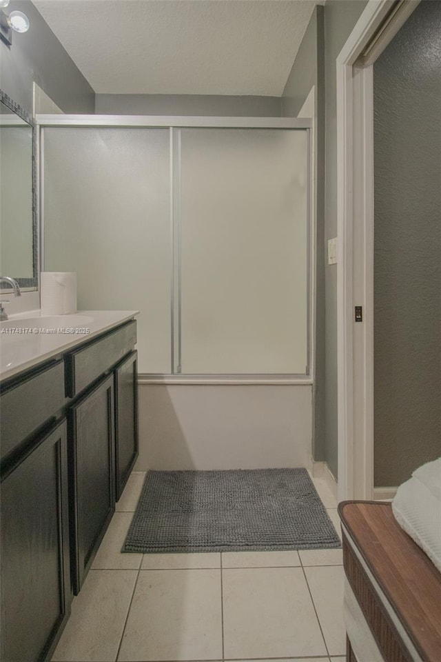 bathroom with shower / bath combination with glass door, vanity, and tile patterned floors