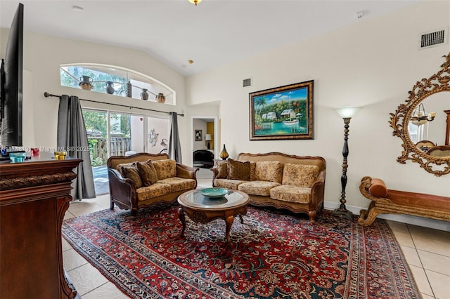 living room featuring light tile patterned floors, baseboards, visible vents, and vaulted ceiling