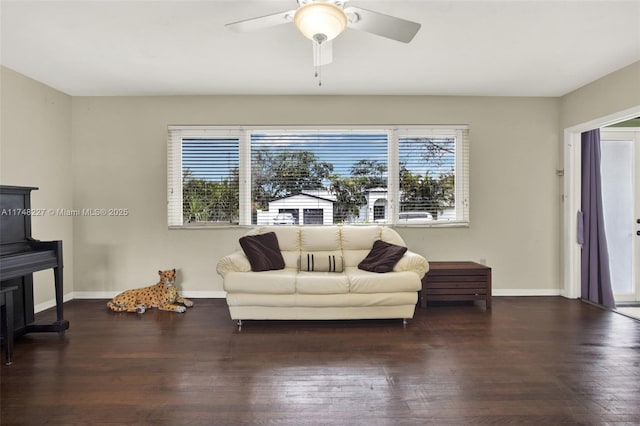 living room featuring dark wood-type flooring, plenty of natural light, and baseboards