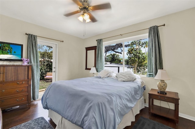 bedroom featuring ceiling fan, wood finished floors, baseboards, and access to outside