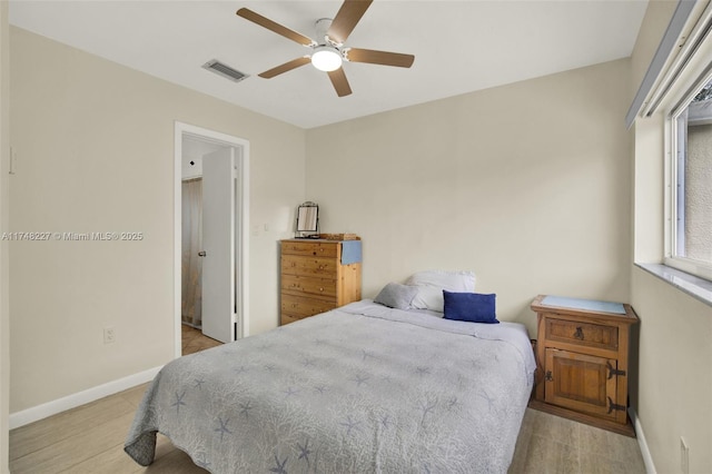 bedroom with a ceiling fan, visible vents, and baseboards