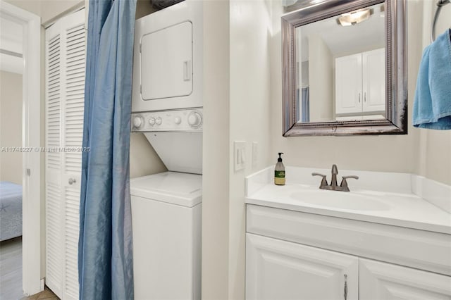 bathroom with stacked washer and dryer and vanity