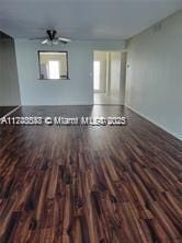 interior space with dark wood-style floors and ceiling fan