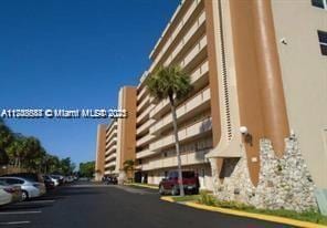 view of building exterior featuring uncovered parking