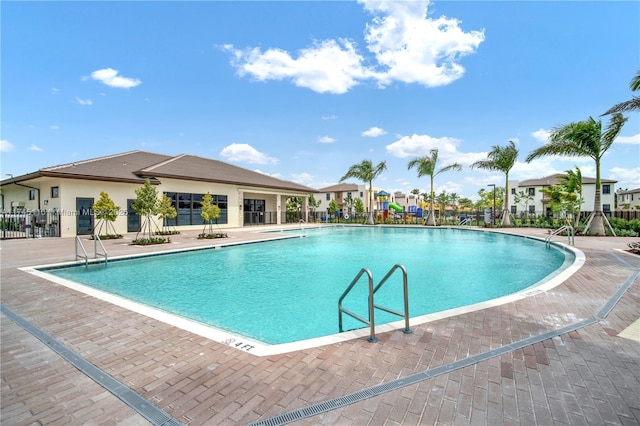 pool with fence and a patio