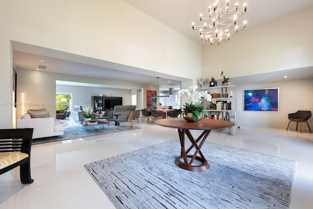 foyer with a towering ceiling, an inviting chandelier, visible vents, and tile patterned floors