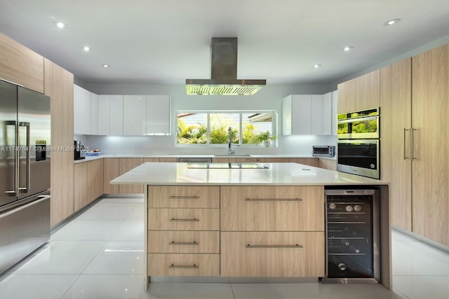 kitchen featuring wine cooler, appliances with stainless steel finishes, modern cabinets, and island exhaust hood