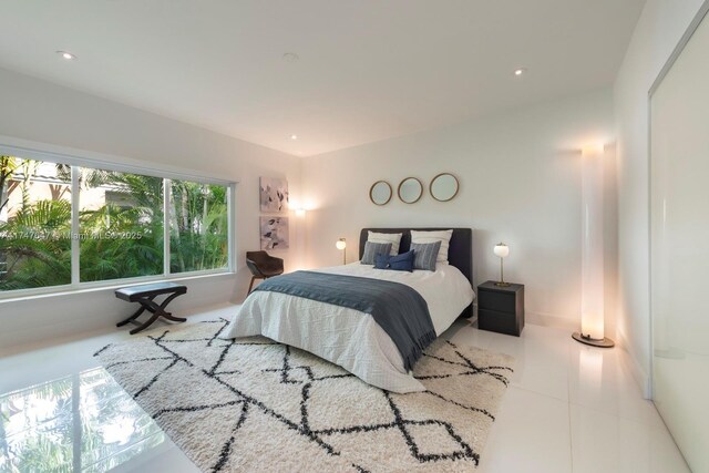 bedroom with tile patterned floors and recessed lighting