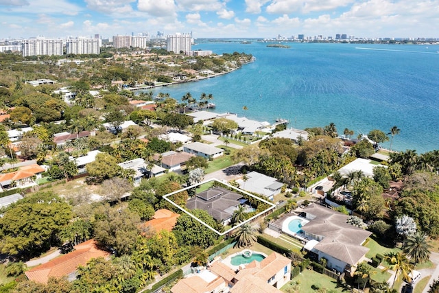 drone / aerial view featuring a city view and a water view
