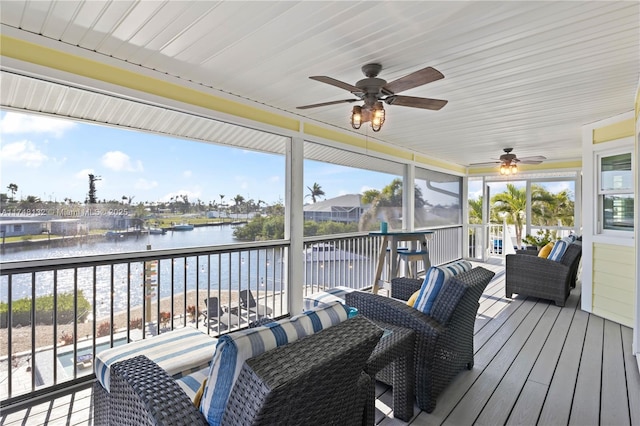 deck featuring a water view and ceiling fan