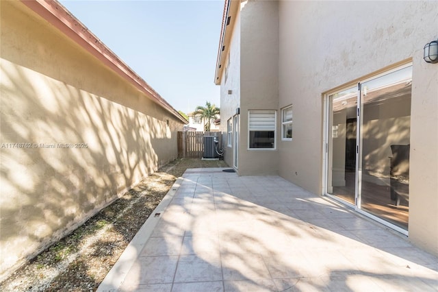 view of patio / terrace featuring fence and central AC unit