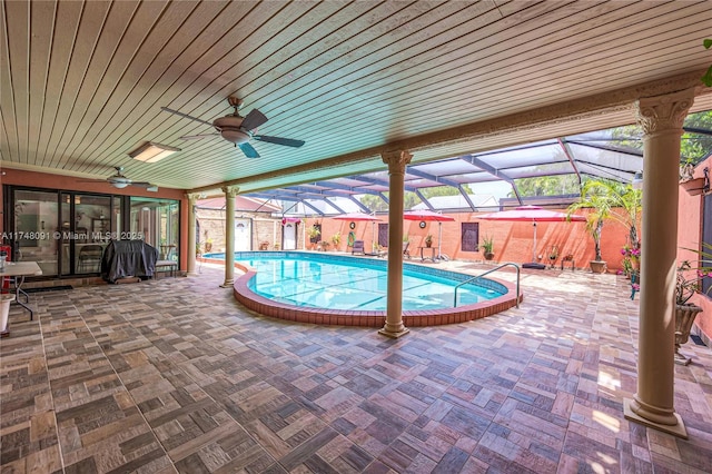 outdoor pool featuring a lanai, a patio area, ceiling fan, and area for grilling