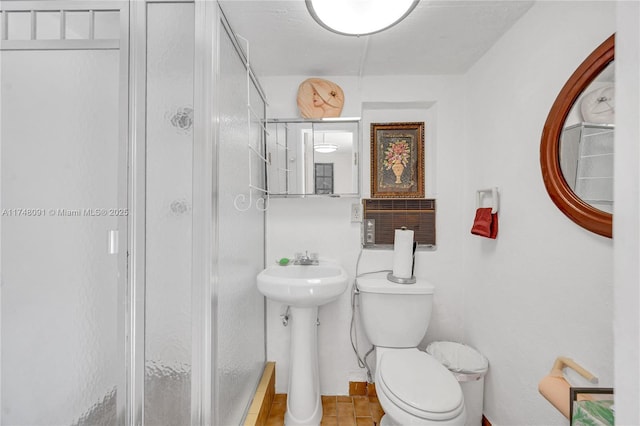 full bathroom featuring toilet and a stall shower