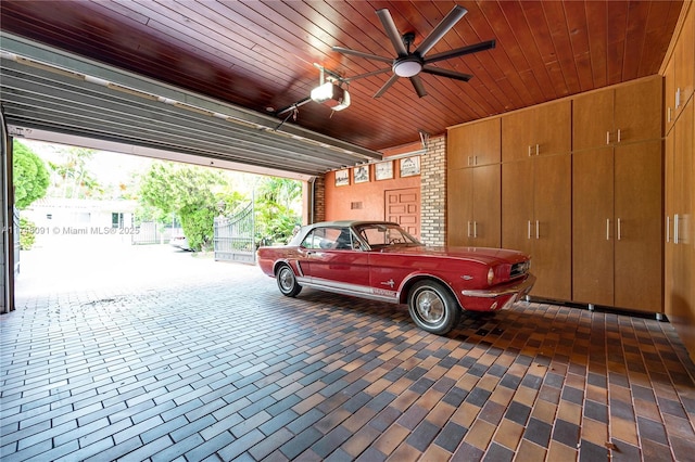 garage with a garage door opener and ceiling fan