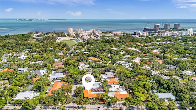 birds eye view of property with a water view and a city view