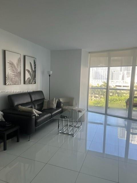 living area with expansive windows and light tile patterned floors