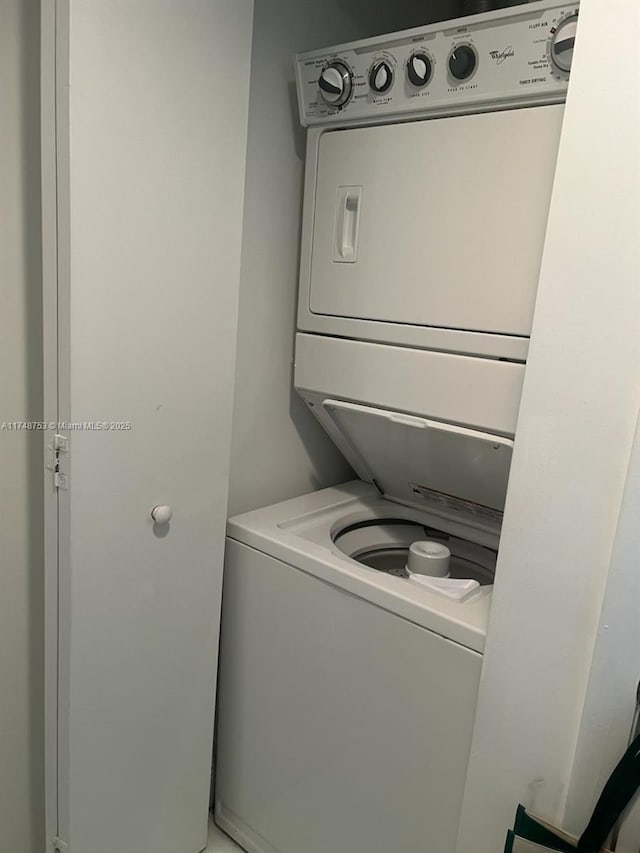 laundry area with laundry area and stacked washer / drying machine