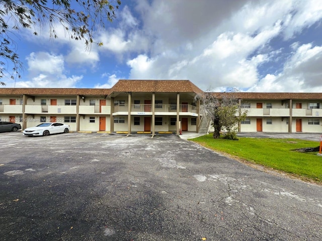 view of property featuring uncovered parking