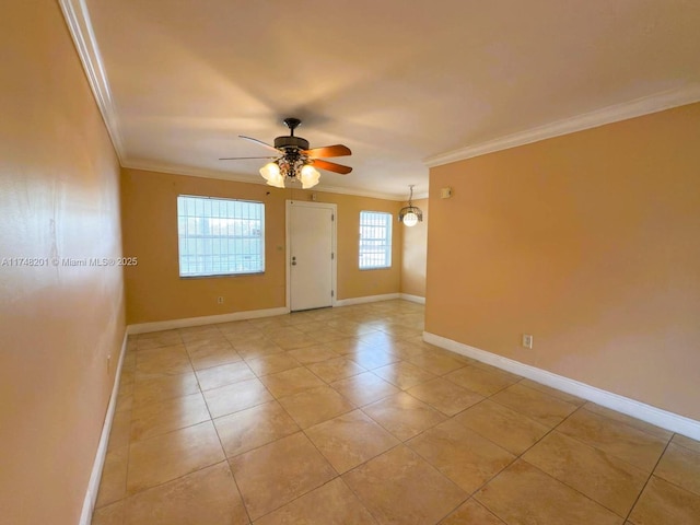 unfurnished room featuring ceiling fan, ornamental molding, light tile patterned floors, and baseboards