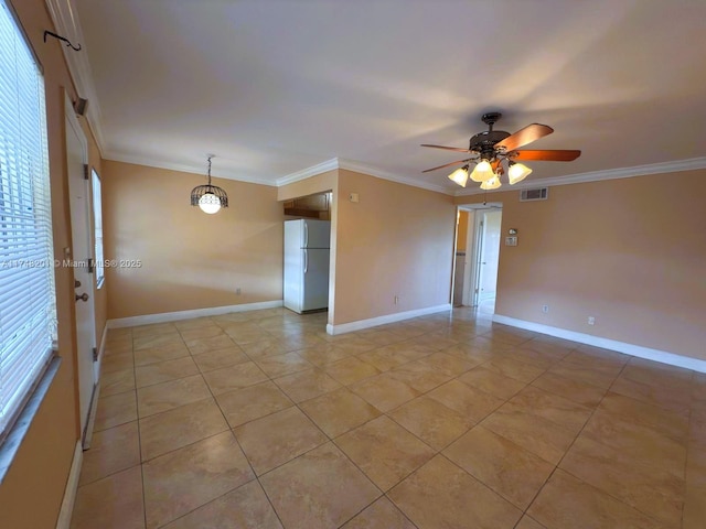 spare room featuring visible vents, crown molding, and baseboards