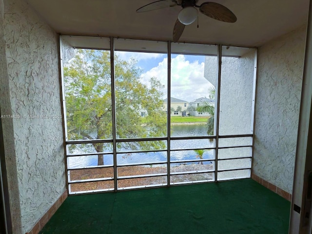 unfurnished sunroom featuring a water view