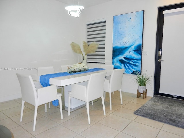 dining room featuring light tile patterned floors and baseboards