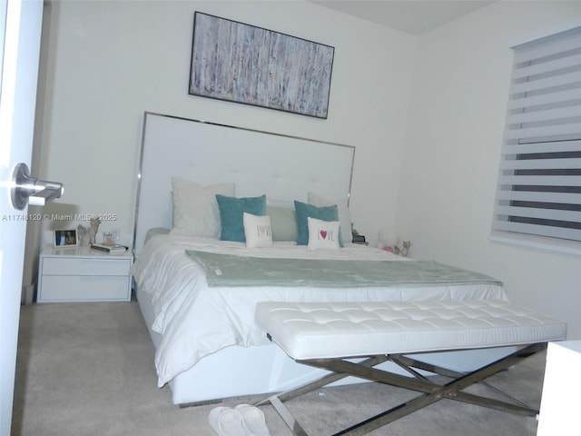 bedroom featuring light colored carpet