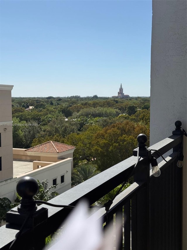 balcony featuring a view of trees