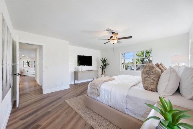 bedroom with dark wood finished floors, baseboards, ceiling fan, and visible vents