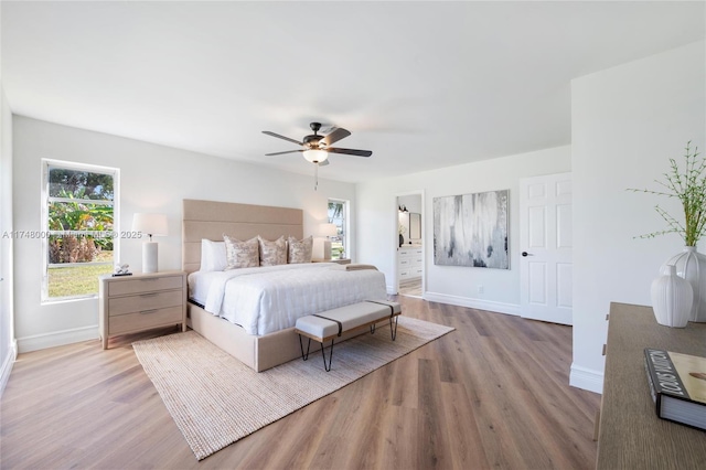 bedroom with ceiling fan, light wood finished floors, and baseboards