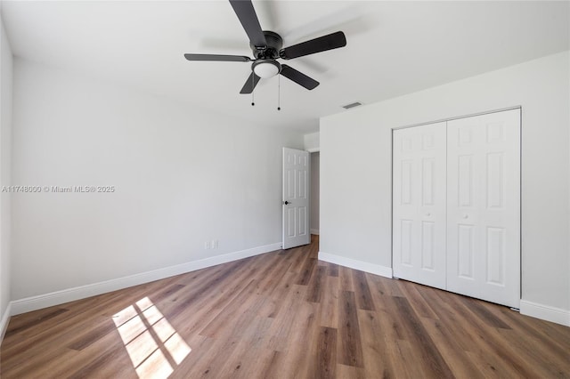 unfurnished bedroom with baseboards, visible vents, and wood finished floors