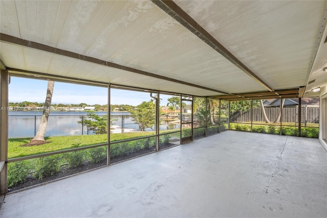 unfurnished sunroom featuring a water view