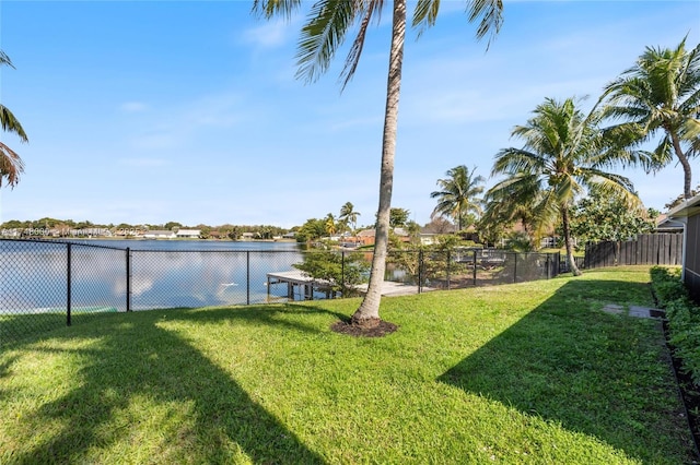 view of yard with fence and a water view