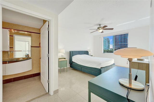 bedroom featuring light tile patterned floors, ceiling fan, and baseboards