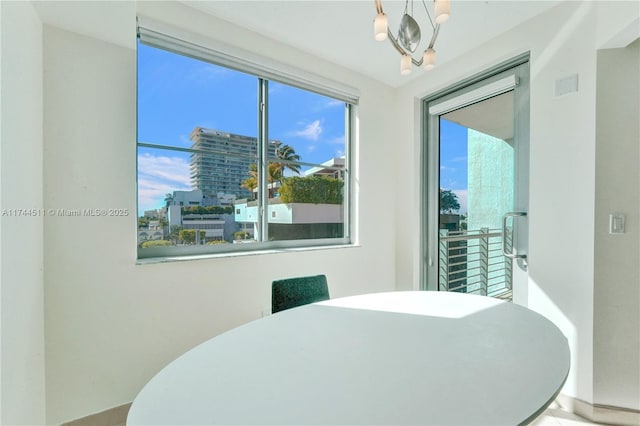 dining space with a city view and a notable chandelier