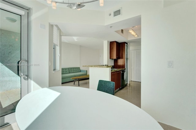 dining area featuring light tile patterned floors and visible vents