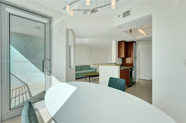 dining space featuring light tile patterned floors and visible vents