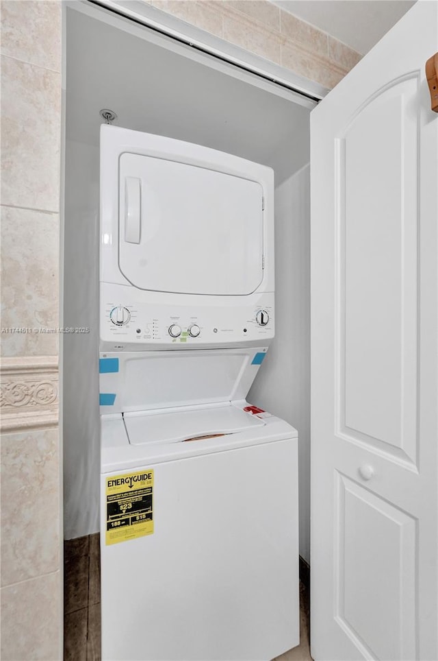 laundry room featuring stacked washing maching and dryer and laundry area