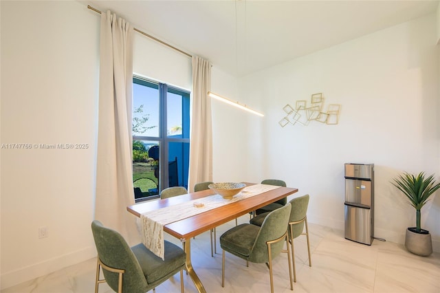 dining room with marble finish floor and baseboards