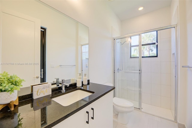 bathroom featuring toilet, a stall shower, recessed lighting, and vanity