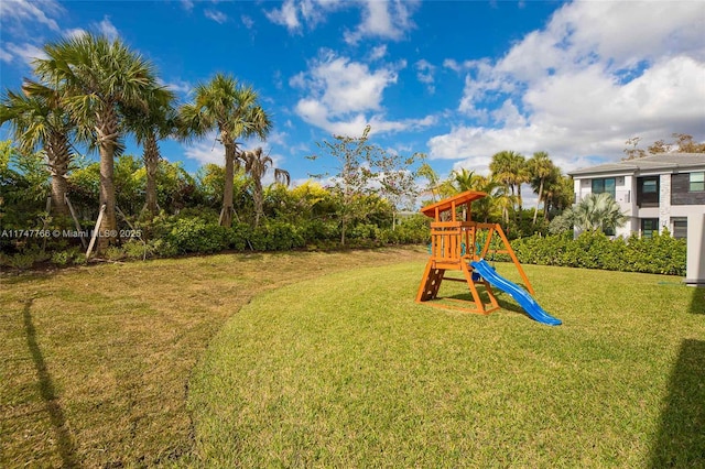 view of playground with a lawn