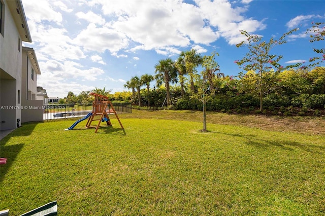 view of yard featuring a playground and fence