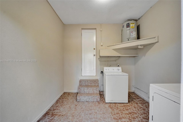 washroom with laundry area, electric water heater, washer and clothes dryer, and baseboards