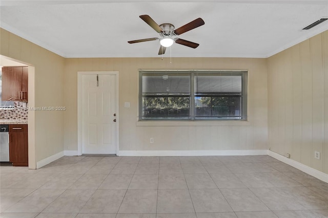 empty room with light tile patterned floors, crown molding, visible vents, and a ceiling fan