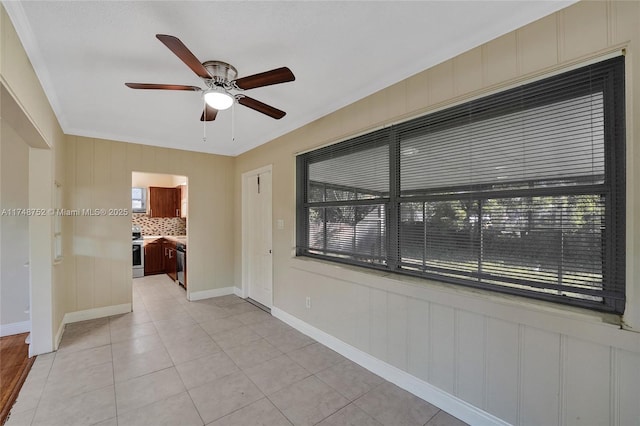 empty room featuring light tile patterned floors, plenty of natural light, and a ceiling fan