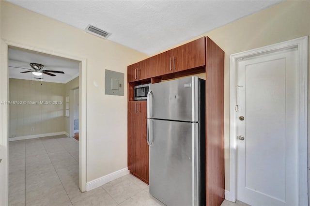 kitchen with light tile patterned floors, stainless steel appliances, a ceiling fan, visible vents, and baseboards