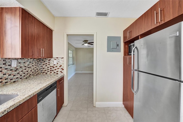 kitchen featuring tasteful backsplash, electric panel, visible vents, appliances with stainless steel finishes, and light stone counters