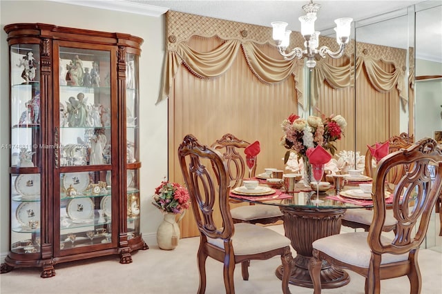 dining space with crown molding, carpet floors, and an inviting chandelier