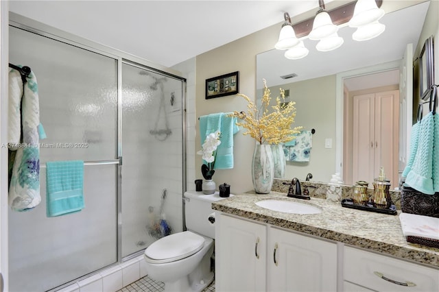 bathroom featuring a stall shower, vanity, and toilet