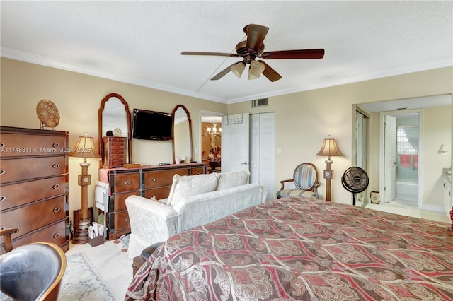 bedroom featuring visible vents, crown molding, a textured ceiling, and ensuite bathroom